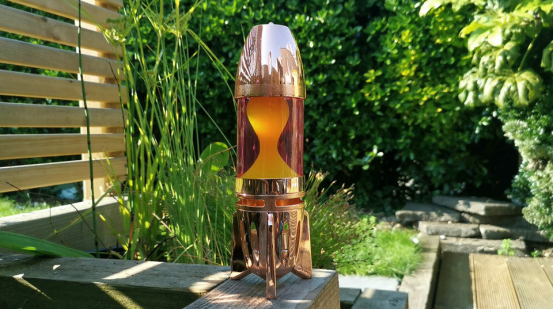 This copper rocket lava lamp pairs with greenery for a surreal indoor jungle.